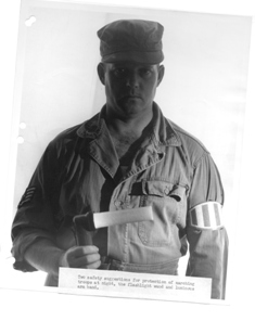 Young military man with flashlight